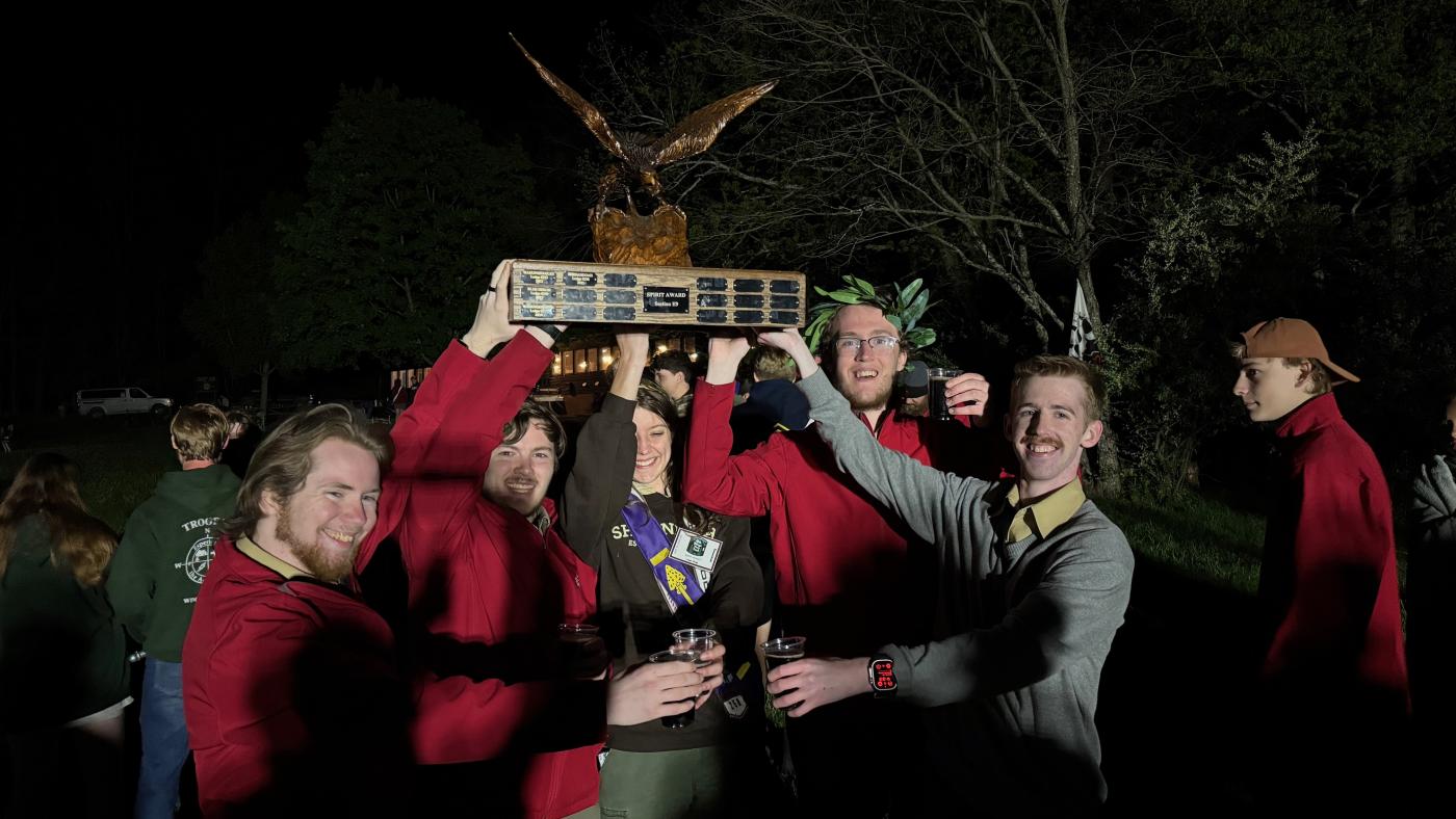 Donathan and other scouts lifting an eagle trophy